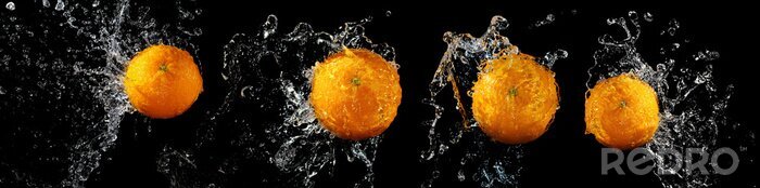 Canvas Verse sinaasappelen op een zwarte achtergrond