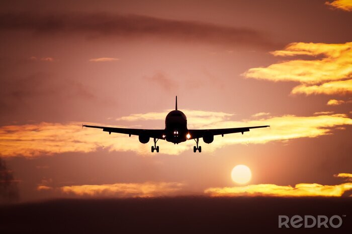 Canvas vliegtuig in de zonsondergang hemel