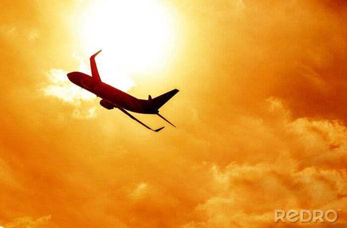 Canvas Vliegtuig silhouet zonsondergang op de achtergrond