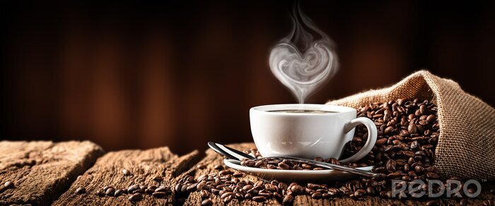 Canvas  White Cup Of Hot Coffee With Heart Shaped Steam On Old Weathered Table With Burlap Sack And Beans