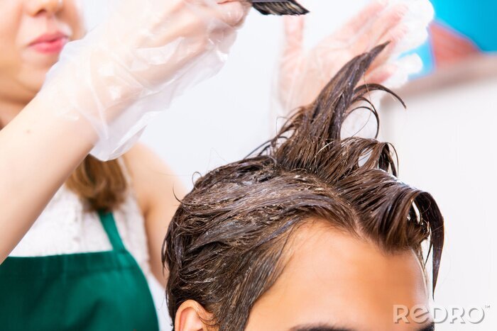 Canvas Woman hairdresser applying dye to man hair