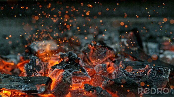 Fotobehang Barbecue Grill Pit With Glowing And Flaming Hot Charcoal Briquettes, Close-Up