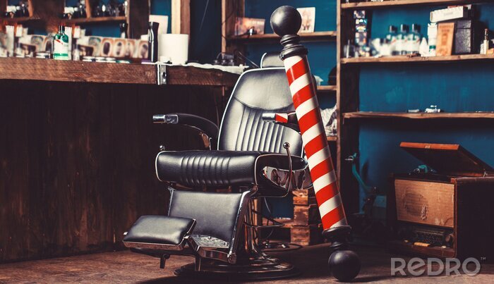Fotobehang Barber shop pole. Logo of the barbershop, symbol. Stylish vintage barber chair. Hairstylist in barbershop interior. Barber shop chair. Barbershop armchair, hairdresser, hair salon, barber shop for men