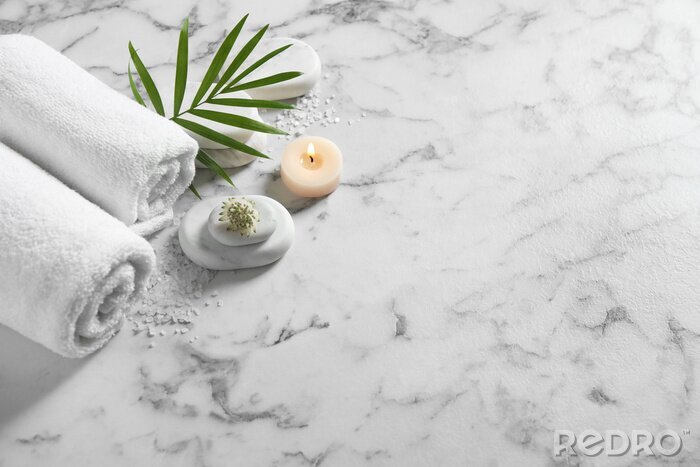 Fotobehang Beautiful composition with spa stones on white marble table, above view