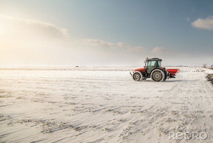 Fotobehang Boer met tractor zaaien - zaaien van gewassen op landbouwgronden in de winter