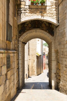 Fotobehang Boog over oude smalle straat van Europese stad. Girona