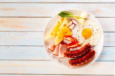 Fotobehang Breakfast - fried egg and sausages, cheese, ham and vegetables