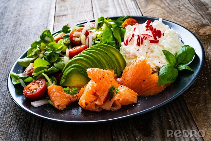 Fotobehang Breakfast - smoked salmon, cottage cheese, avocado and vegetable salad on wooden table