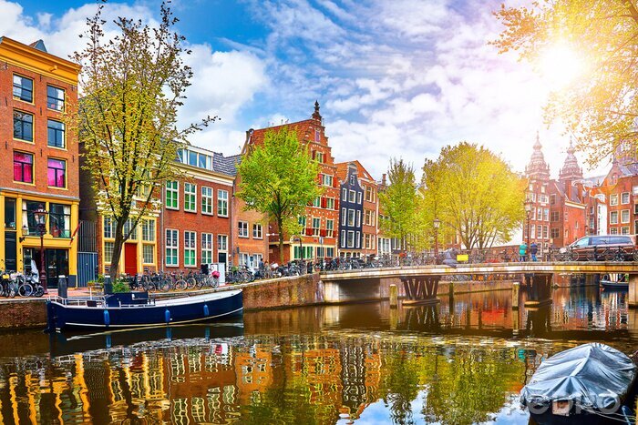 Fotobehang Channel in Amsterdam Netherlands houses river Amstel landmark