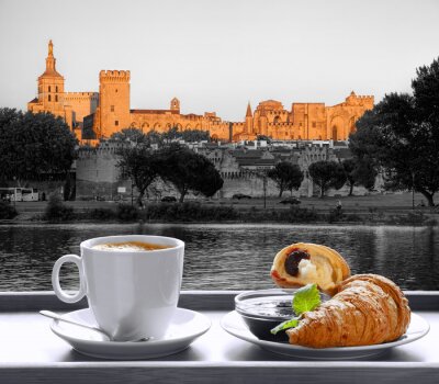 Coffee with croissants against Avignon town in Provence, France