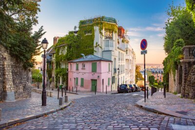 Comfortabele oude straat met roze huis bij de zonnige zonsopgang, kwart Montmartre in Parijs, Frankrijk