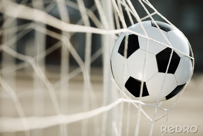 Fotobehang De bal trappen in een wedstrijd