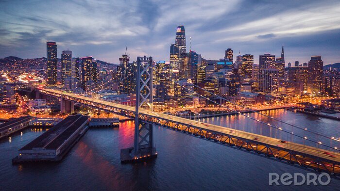 Fotobehang De verlichte Bay Bridge en de skyline van San Francisco &#39;s nachts