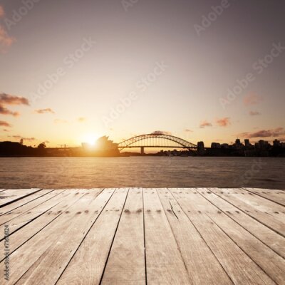 Fotobehang De waterkant van Sydney met de brug en het operagebouw tegen de ondergaande zon