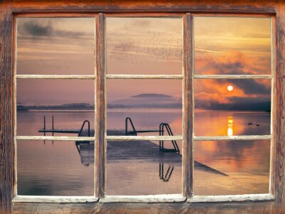 Fotobehang Een raam met uitzicht op de zonsopgang