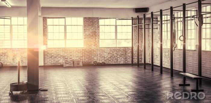 Fotobehang Een sportschool met grote ramen en bakstenen muren