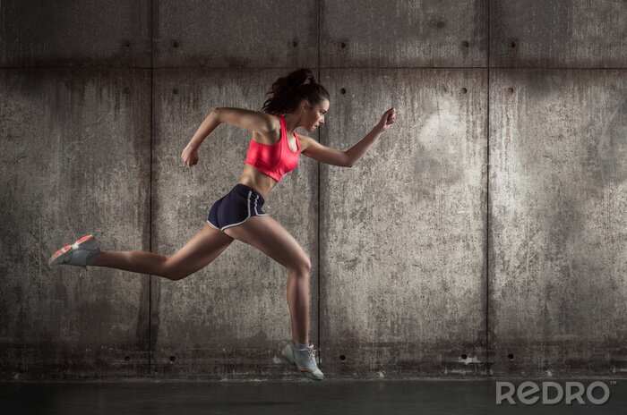 Fotobehang Een vrouw in sportkleding rent