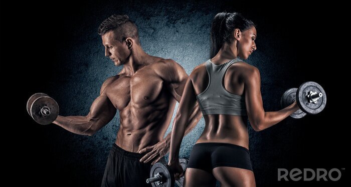 Fotobehang Gespierde man en vrouw met halters op een donkere achtergrond