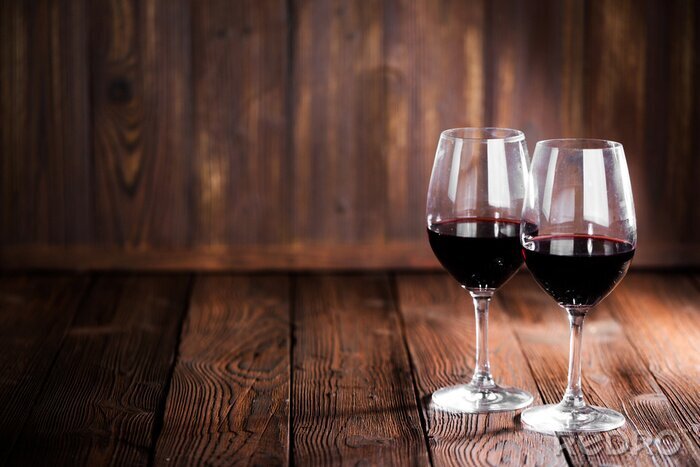 Fotobehang Glazen met rode wijn op hout