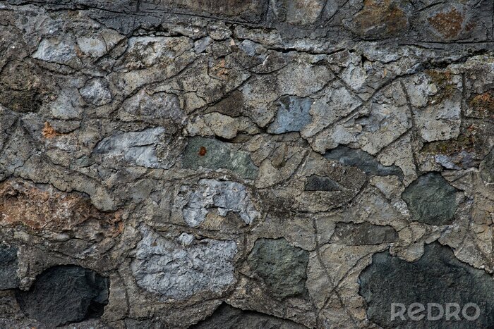 Fotobehang Grijs gekleurde steen aan een muur
