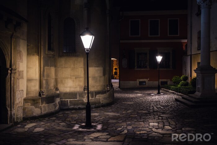 Fotobehang illuminated street at night. Old european city