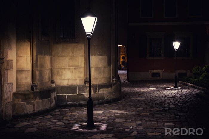 Fotobehang illuminated street at night. Old european city