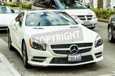 Fotobehang LOS ANGELES - DECEMBER 18, 2013: white Mercedes Benz SL 550 parked on Rodeo Drive. The brand is used automobiles, buses, coaches, and trucks. The headquarters are in Stuttgart, Germany.