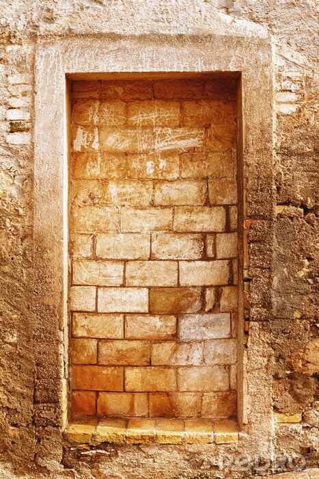 Fotobehang Muur met een dichtgemetseld raam