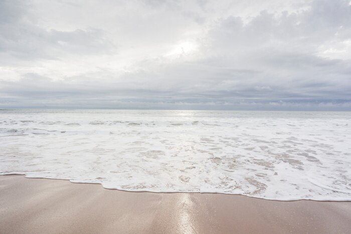 Fotobehang Ocean, sea, sand beach with black clouds on horizon. Zen picture (France-Vendée-Les Sables-d'Olonne)