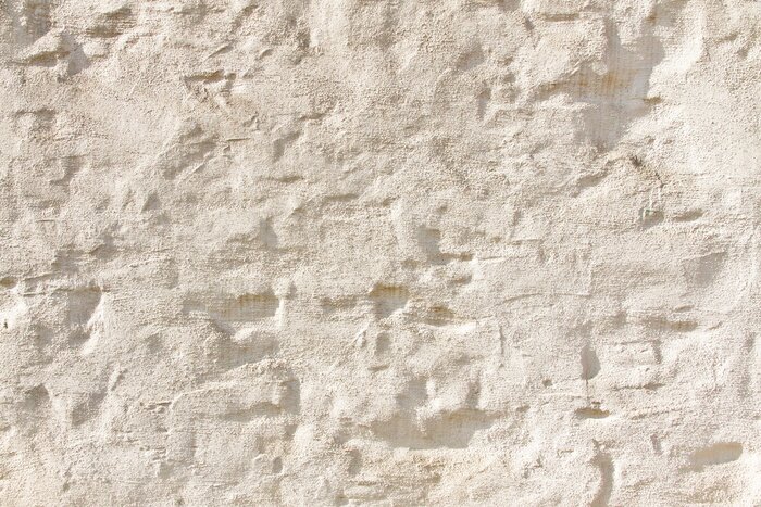 Fotobehang Ongelijkmatige lichtgekleurde muur