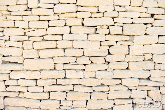 Fotobehang Onregelmatige beige stenen muur