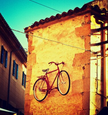 Fotobehang Oude fiets aan de muur