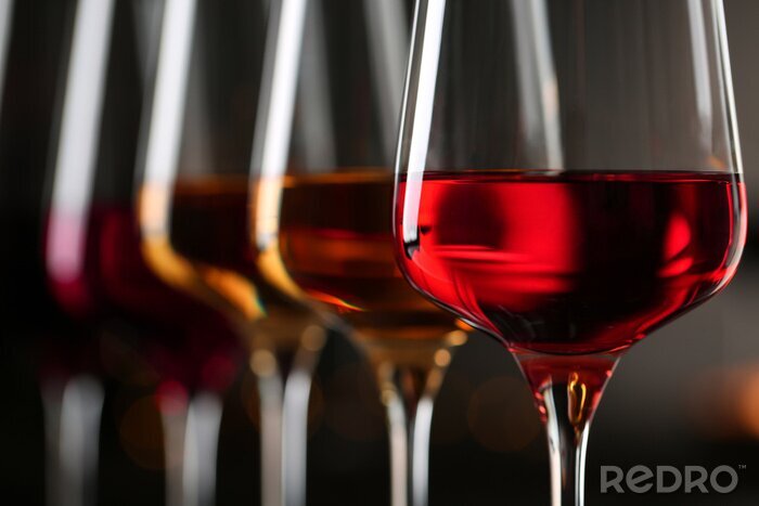 Fotobehang Row of glasses with different wines on blurred background, closeup