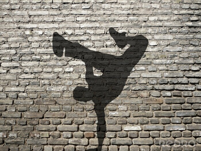 Fotobehang Schaduw van een breakdancer op de muur