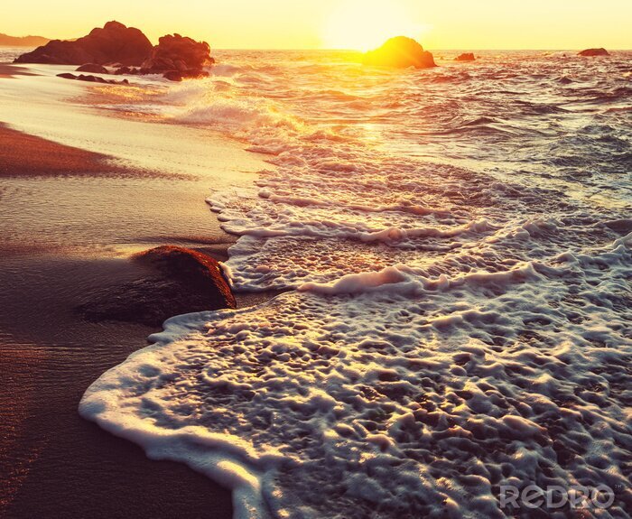 Fotobehang Schuimende zeegolven in de zon