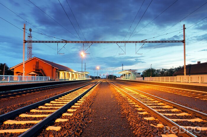 Fotobehang Station in motion blur 's nachts, spoorweg