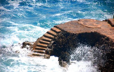 Fotobehang Stenen trap leidt naar de bewegende zee