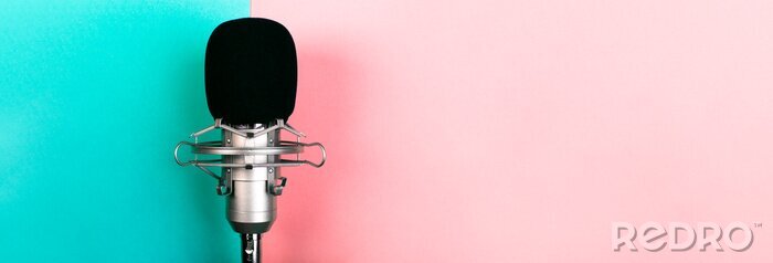 Fotobehang studio microphone on a blue pink background, panoramic mock-up with space for text