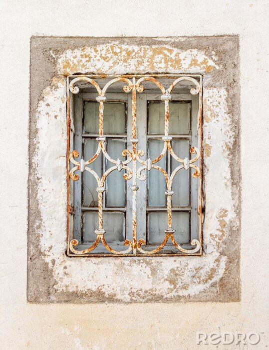 Fotobehang Ventana / Ventana Vieja con reja oxidada y muro desportillado