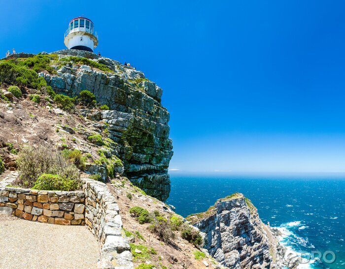 Fotobehang Vuurtoren op de schilderachtige rotsen