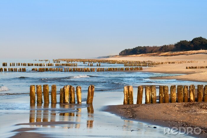 Fotobehang Zee, golven en houten golfbreker
