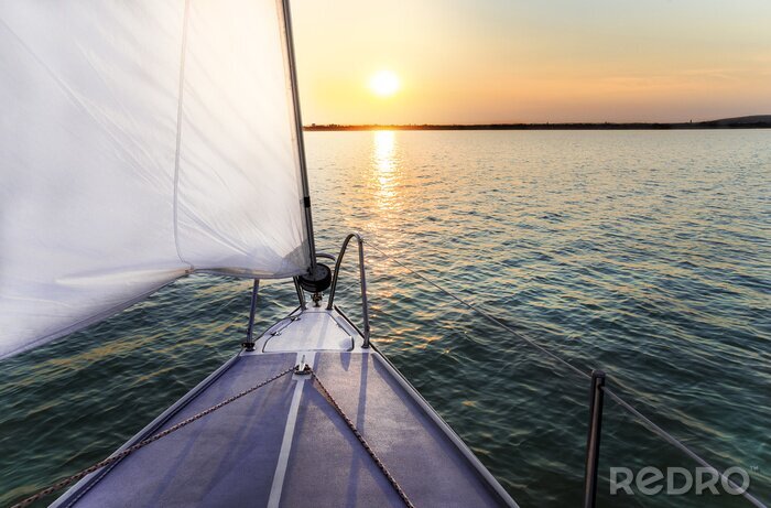 Fotobehang Zeilboot en zonsondergang