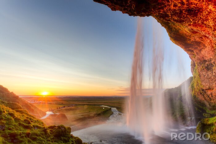 Fotobehang Zonsondergang bij een waterval