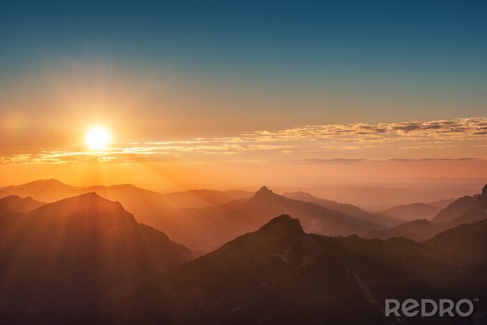 Fotobehang Zonsondergang over de bergen