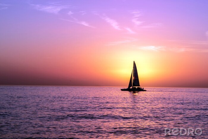 Poster A Sailboat In Front of a Sunset