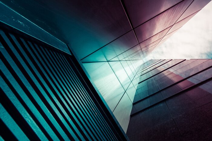 Poster Abstract background. View through modern high rising skyscraper chimney upwards to blue sky with white clouds - abstract architecture detail background in turquoise teal blue to burgundy purple colors