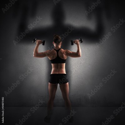 Poster Atletische vrouw met halters op een zwarte achtergrond