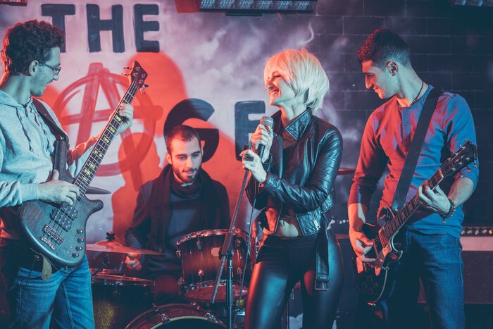 Poster Band playing on stage making music