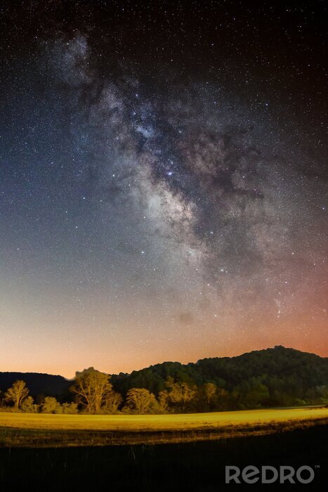 Poster Beautiful scenery of the Milky Way galaxy in the night sky over a landscape