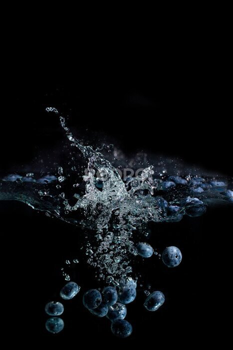 Poster bright juicy fruits with splashes fly into the aquarium on a black background